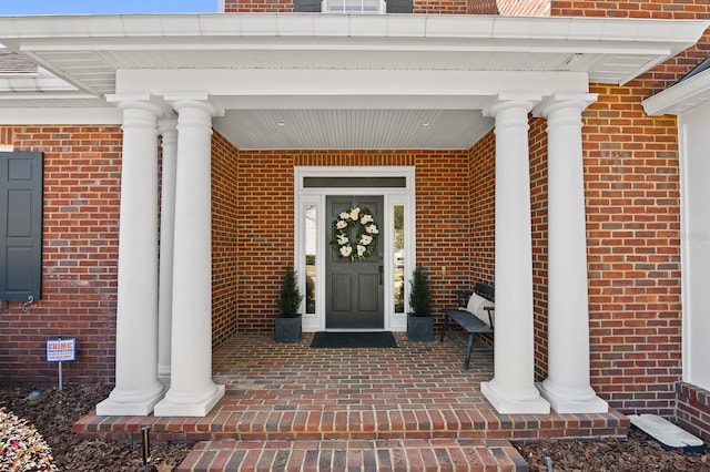 property entrance featuring brick siding