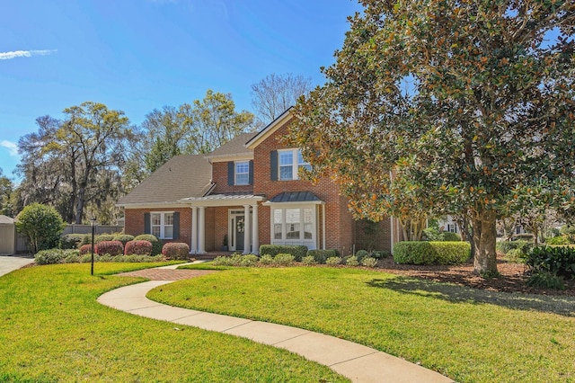 view of front facade featuring a front yard and brick siding