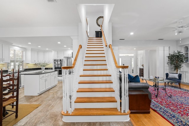 stairway featuring recessed lighting, ceiling fan, and wood finished floors