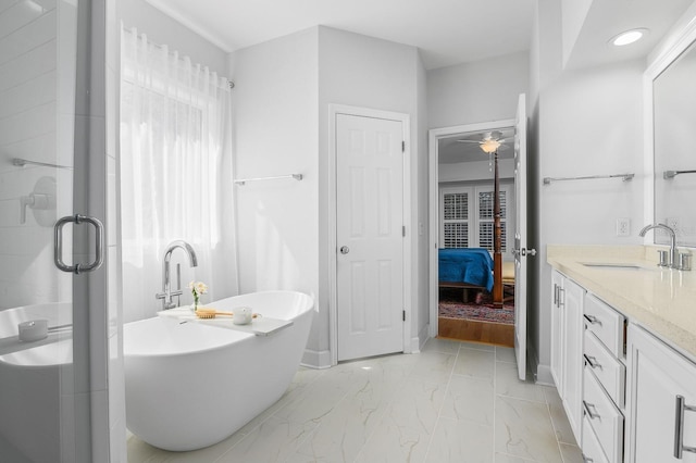 ensuite bathroom featuring connected bathroom, a freestanding bath, a stall shower, marble finish floor, and vanity