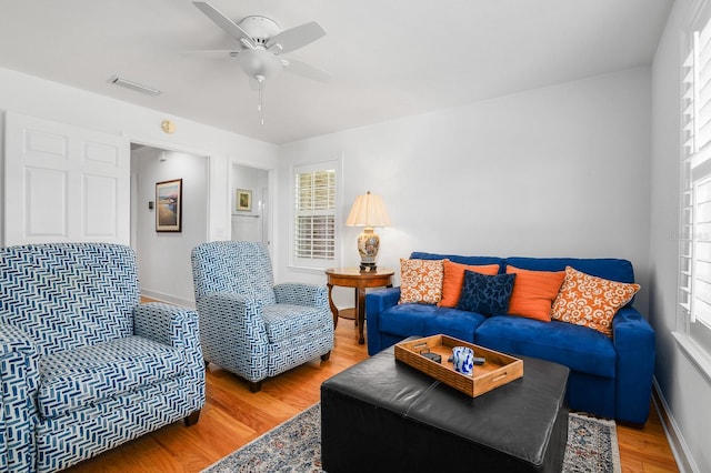 living area with visible vents, light wood-style flooring, and a healthy amount of sunlight