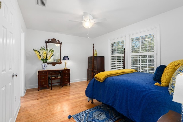 bedroom with light wood-style flooring, baseboards, visible vents, and ceiling fan