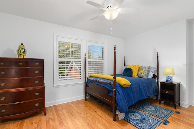 bedroom featuring baseboards, light wood-type flooring, and ceiling fan