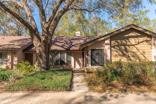 view of front of home with roof with shingles and a chimney