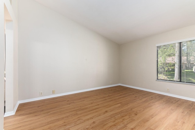 unfurnished room with light wood finished floors and baseboards