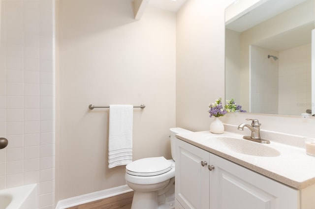 full bath with shower / bath combination, baseboards, toilet, wood finished floors, and vanity