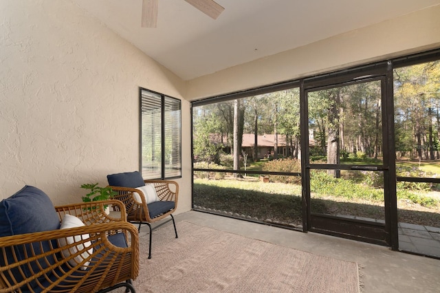 sunroom / solarium with lofted ceiling and ceiling fan