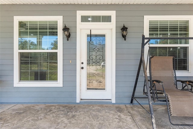 view of exterior entry with covered porch