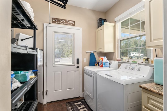 laundry area featuring dark wood-style floors, separate washer and dryer, cabinet space, and a healthy amount of sunlight