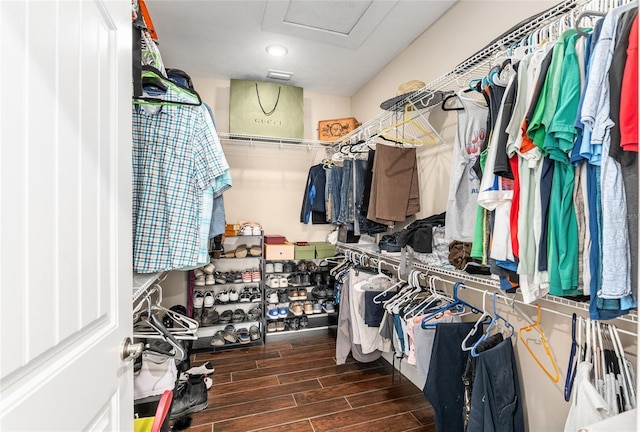 spacious closet with attic access and wood tiled floor