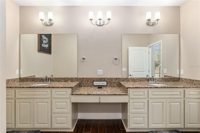 bathroom featuring double vanity, a sink, and wood finished floors