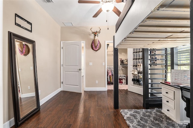 interior space with dark wood-type flooring, visible vents, and baseboards