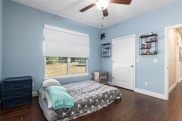 bedroom featuring dark wood finished floors, baseboards, and ceiling fan