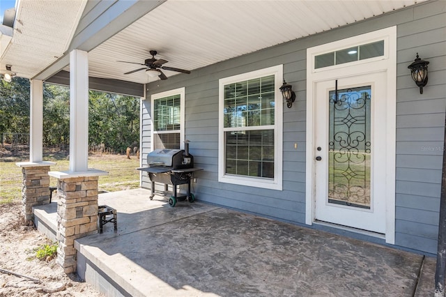 doorway to property with ceiling fan, a porch, and a patio