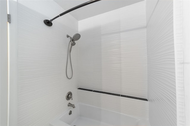 interior details featuring washtub / shower combination