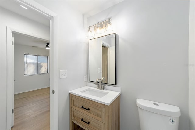 bathroom featuring wood finished floors, vanity, and toilet