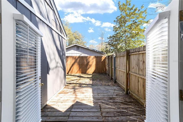 wooden terrace featuring a fenced backyard