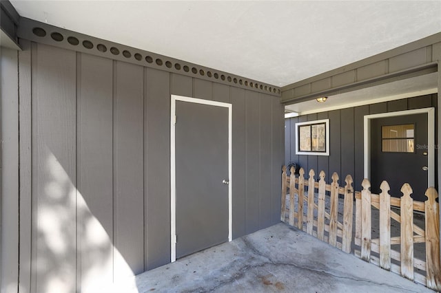 view of exterior entry featuring board and batten siding