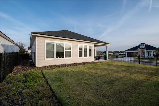 rear view of property featuring a fenced backyard and a yard