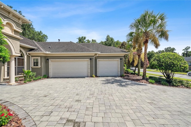 garage with decorative driveway