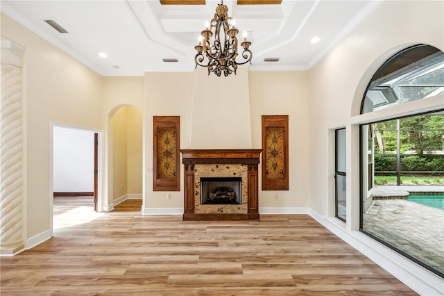 unfurnished living room featuring visible vents, a high ceiling, and ornamental molding