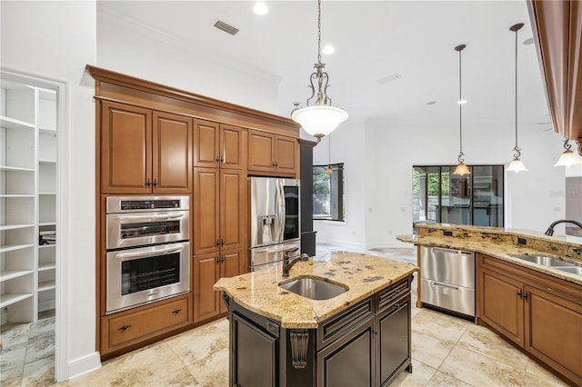 kitchen with visible vents, light stone countertops, stainless steel appliances, and a sink