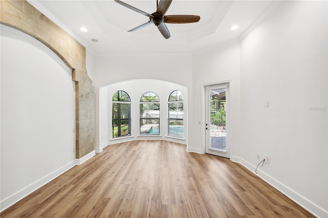 spare room with crown molding and baseboards