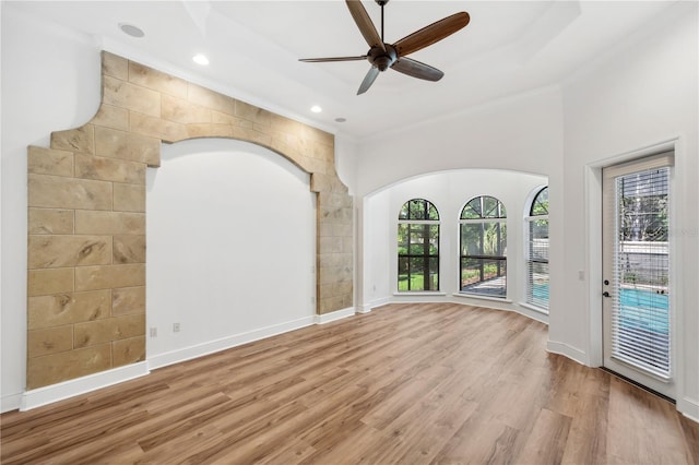 empty room with a ceiling fan, recessed lighting, wood finished floors, and baseboards