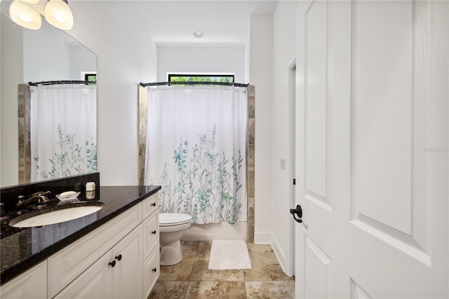 full bath featuring vanity and toilet