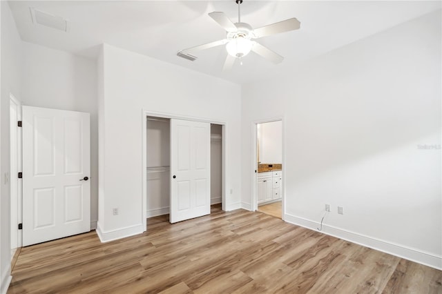 unfurnished bedroom with light wood finished floors, visible vents, baseboards, and a closet