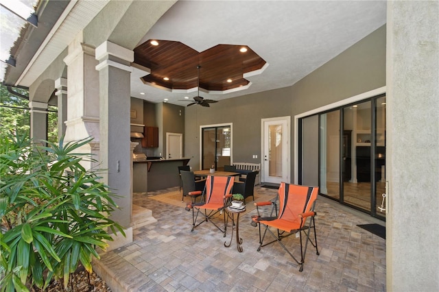 view of patio / terrace with an outdoor kitchen, outdoor dining space, and a ceiling fan