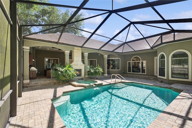 view of swimming pool with a lanai, a patio area, and a pool with connected hot tub