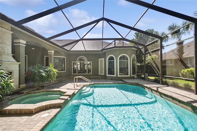 view of pool with a lanai, a patio area, and a pool with connected hot tub