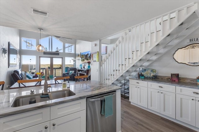 kitchen with visible vents, dark wood finished floors, dishwasher, white cabinets, and a sink