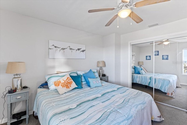 bedroom with visible vents, baseboards, a ceiling fan, a closet, and carpet