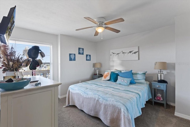 carpeted bedroom with a ceiling fan and baseboards