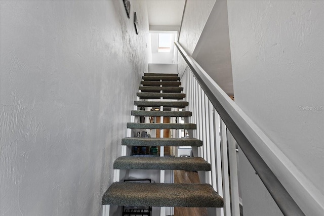 stairs featuring a textured wall