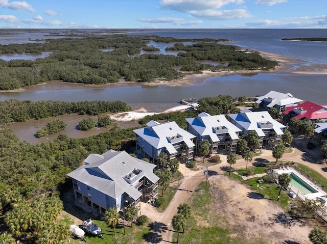 drone / aerial view featuring a water view and a forest view