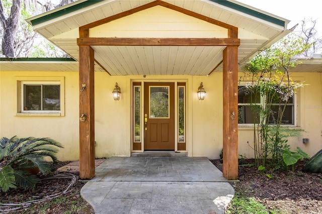 doorway to property with stucco siding