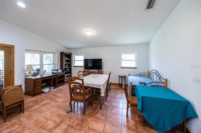 dining area featuring light tile patterned floors, visible vents, and lofted ceiling