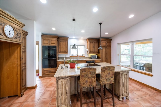 kitchen featuring dobule oven black, a sink, light stone counters, light tile patterned flooring, and brown cabinetry