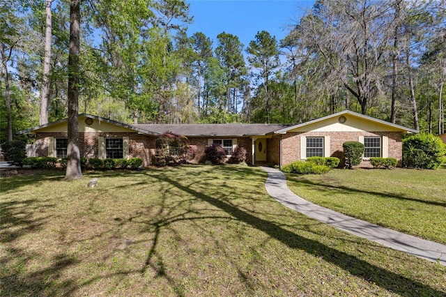 4031 NW 75th St, Gainesville, FL 32606 - ranch-style house with a front lawn and brick siding