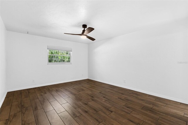 4031 NW 75th St, Gainesville, FL 32606 - spare room with dark wood-style floors, ceiling fan, and baseboards
