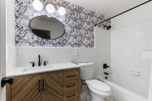 4031 NW 75th St, Gainesville, FL 32606 - full bathroom with vanity, tile walls, toilet, wallpapered walls, and a wainscoted wall