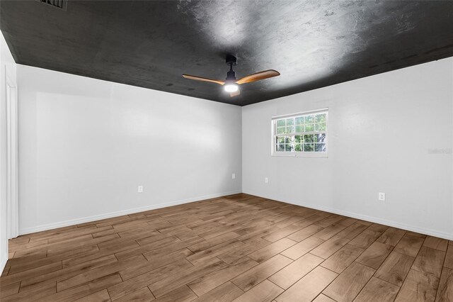 4031 NW 75th St, Gainesville, FL 32606 - spare room with baseboards, wood finished floors, and a ceiling fan