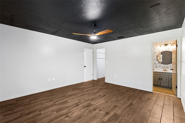 4031 NW 75th St, Gainesville, FL 32606 - unfurnished bedroom with baseboards, ensuite bath, visible vents, a ceiling fan, and wood finished floors