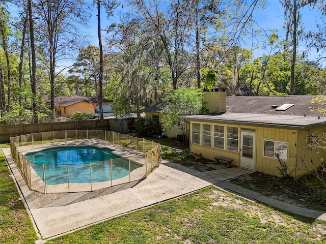 4031 NW 75th St, Gainesville, FL 32606 - view of swimming pool with a fenced in pool, a sunroom, fence, and a patio