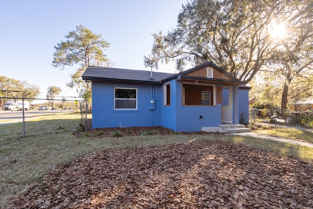 bungalow-style home with fence and stucco siding