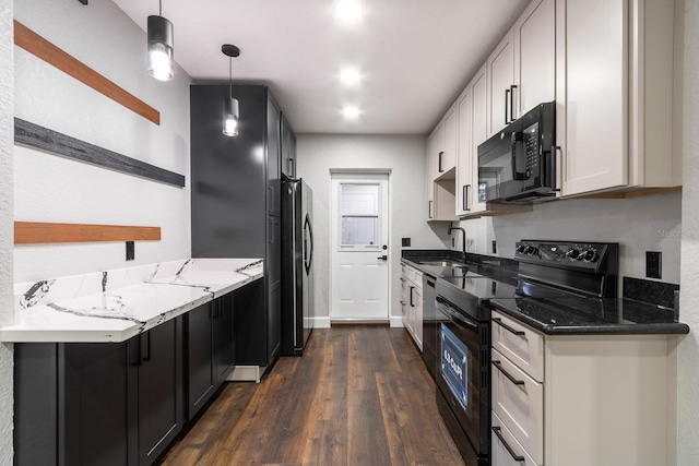 kitchen featuring white cabinets, dark stone counters, black appliances, pendant lighting, and a sink