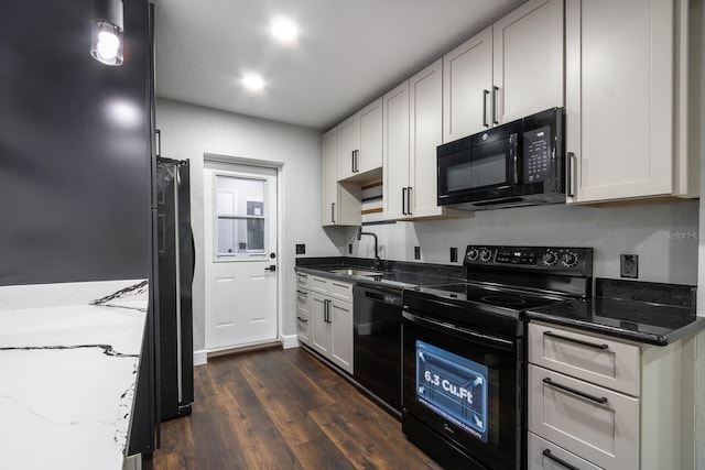 kitchen featuring stone countertops, white cabinetry, a sink, and black appliances